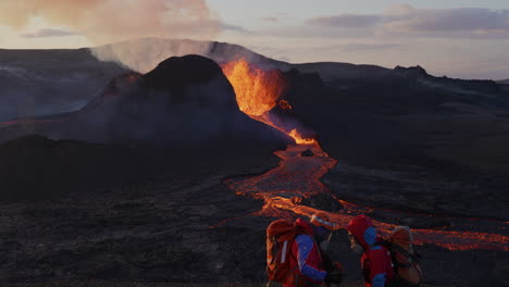 close up shot of two search and rescue worker in protective suit talking about safety in front of erupting volcano in iceland