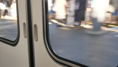 Landscape-view-of-the-train-door-from-inside-the-train-while-train-is-leaving-from-the-station-in-Tokyo-City-4K-UHD-video-movie-footage-short