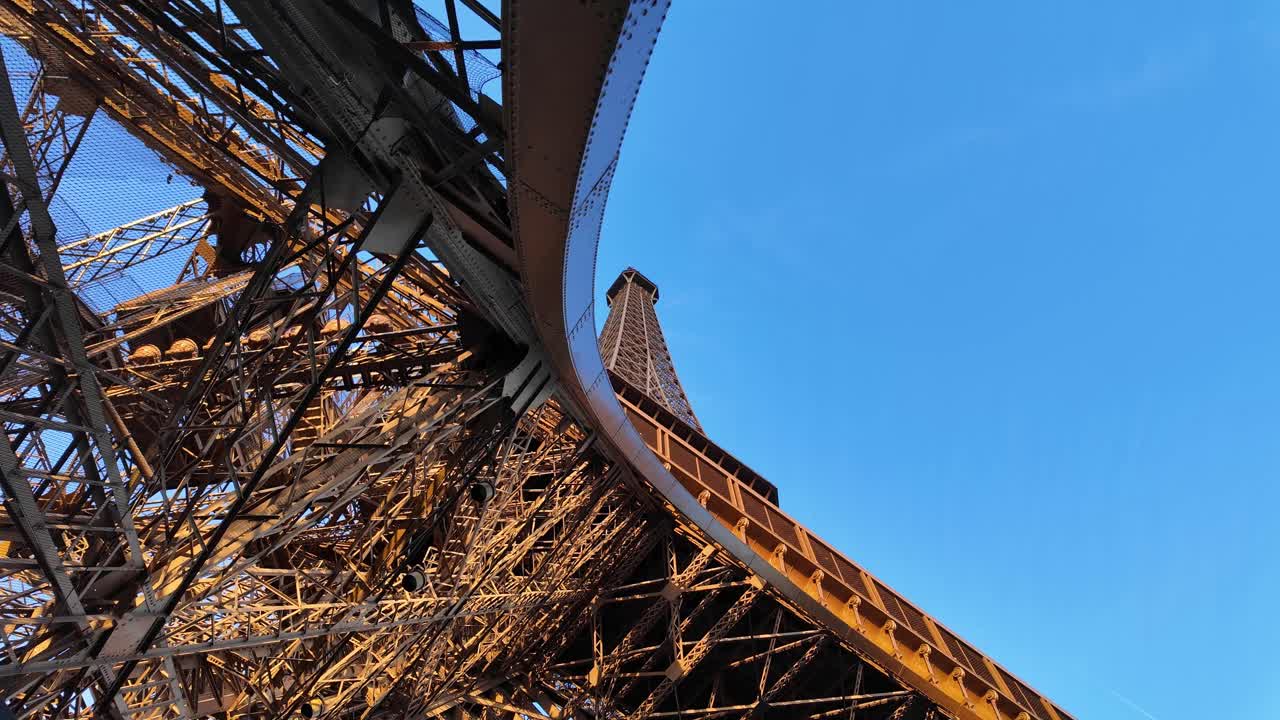 Eiffel Tower Paris France landmark puddle iron structure up-close close up, clear blue sky