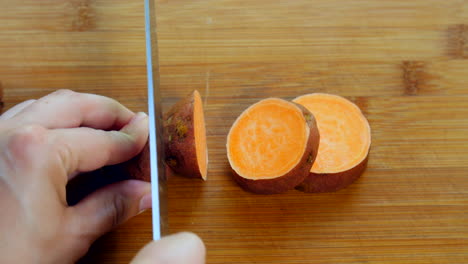 person cut up pieces of sweet potato