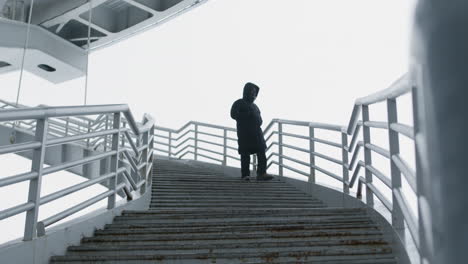 man going downstairs on a bridge