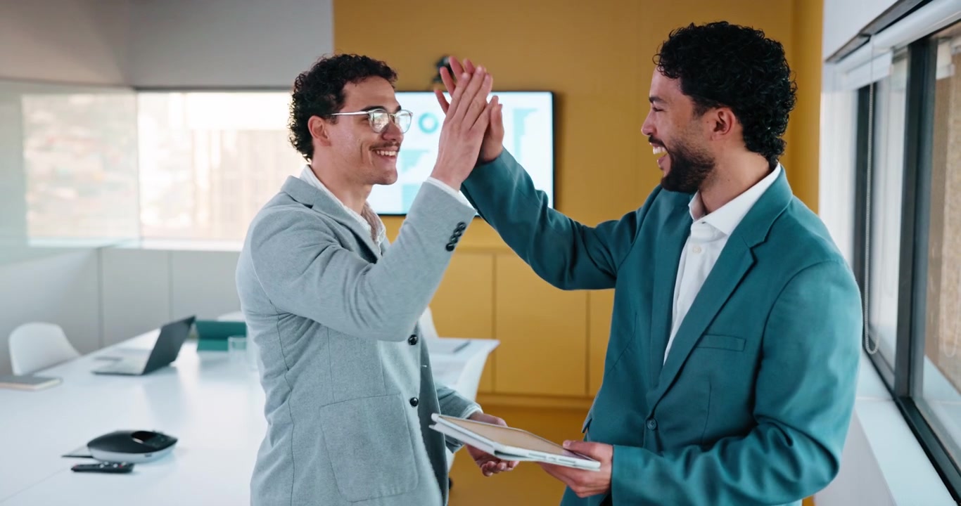 Two Businessmen Celebrating Success with a High Five in Office