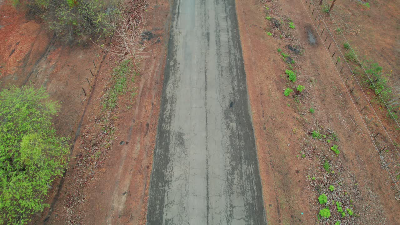 A cracked road surrounded by nature in los esteros de camaguán, venezuela, aerial view