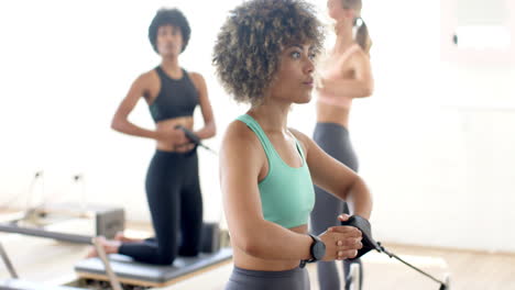 diverse group of friends practicing yoga in bright studio