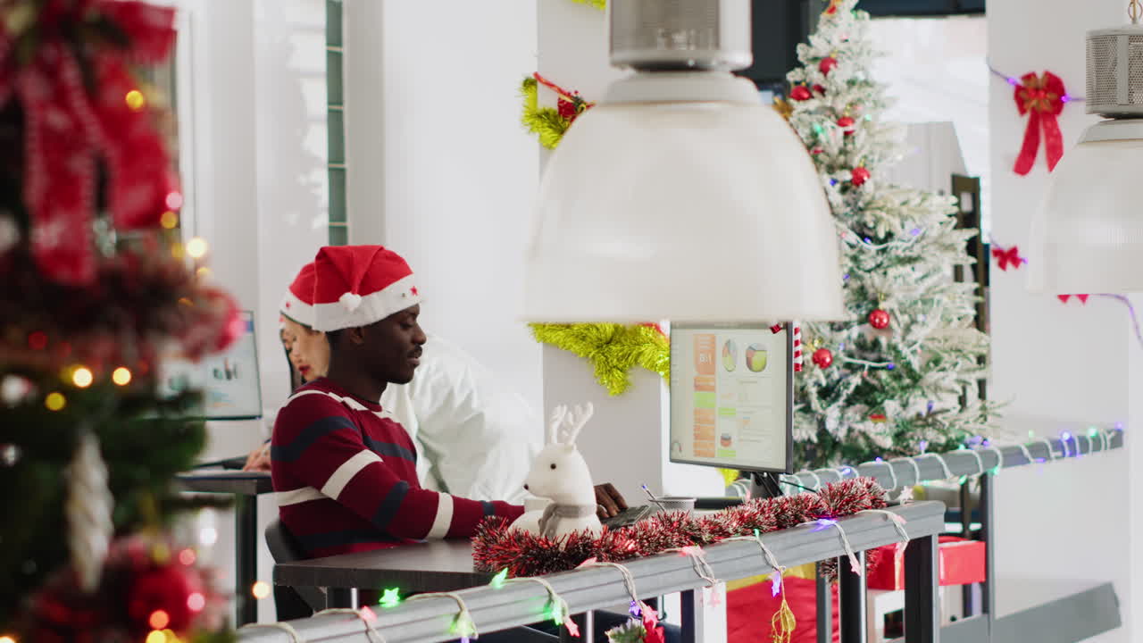 Office decorated for Christmas with people working