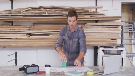 Caucasian-male-surfboard-makers-working-in-his-studio