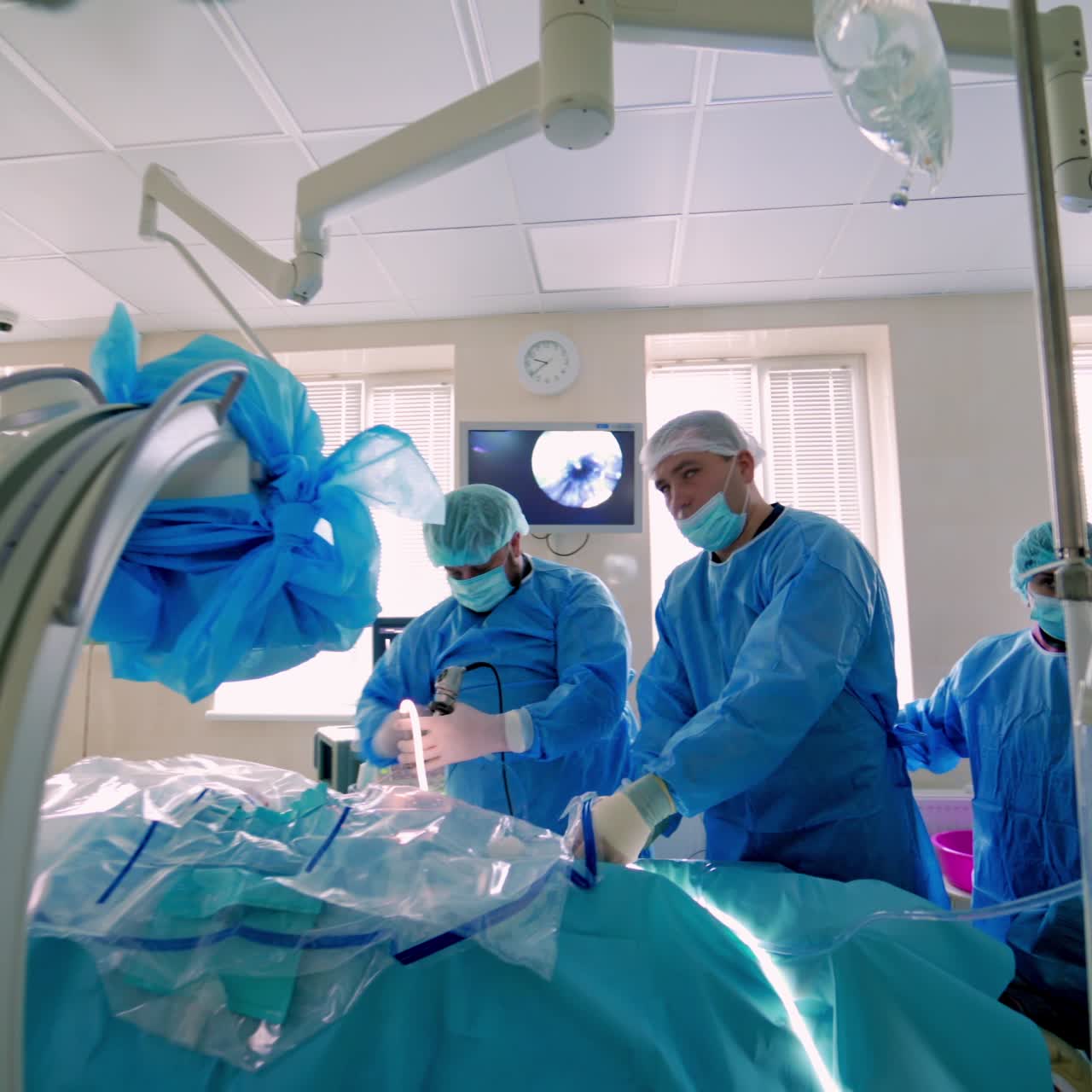 Surgeons surrounding patient on operation table