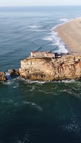 aerial view of nazare coastline in portugal with waves cliffs and atlantic ocean