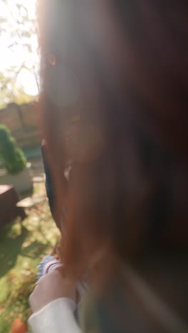 teenage girl wearing a poncho in a garden