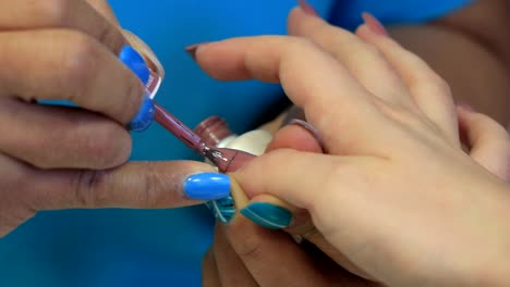 a girl has her fingernails polished