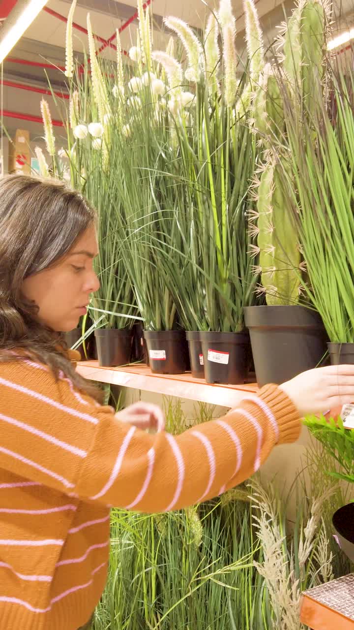 A woman is shopping for plants in a store