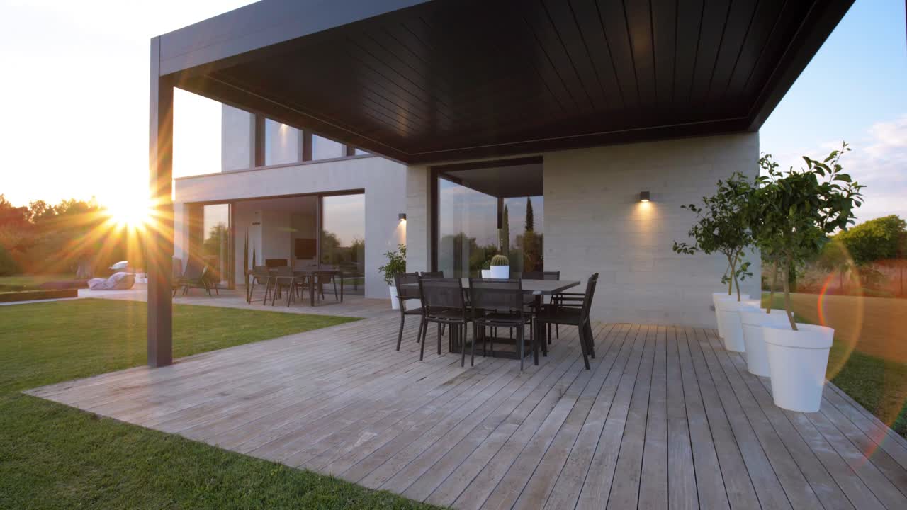 Slow revealing shot of a seating area under a canopy at a villa in Uz&egrave;s during sunset