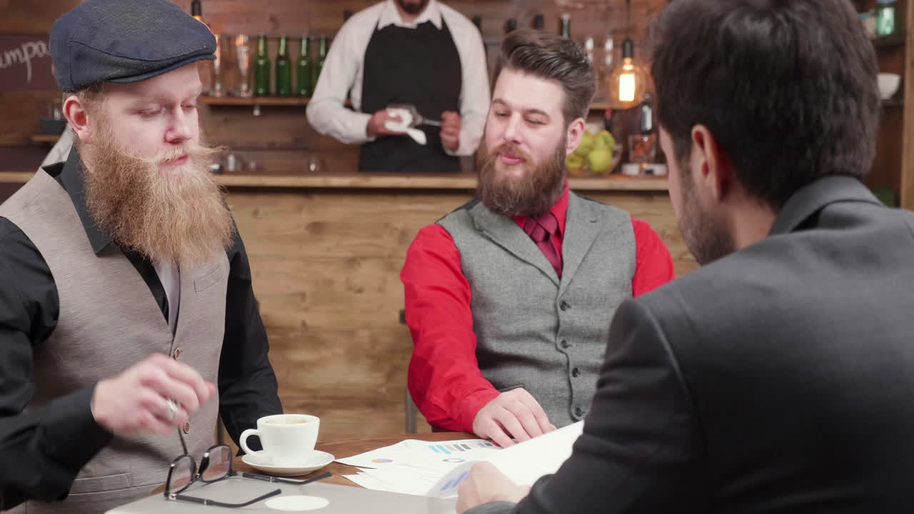 Businessmen at a bar negotiating
