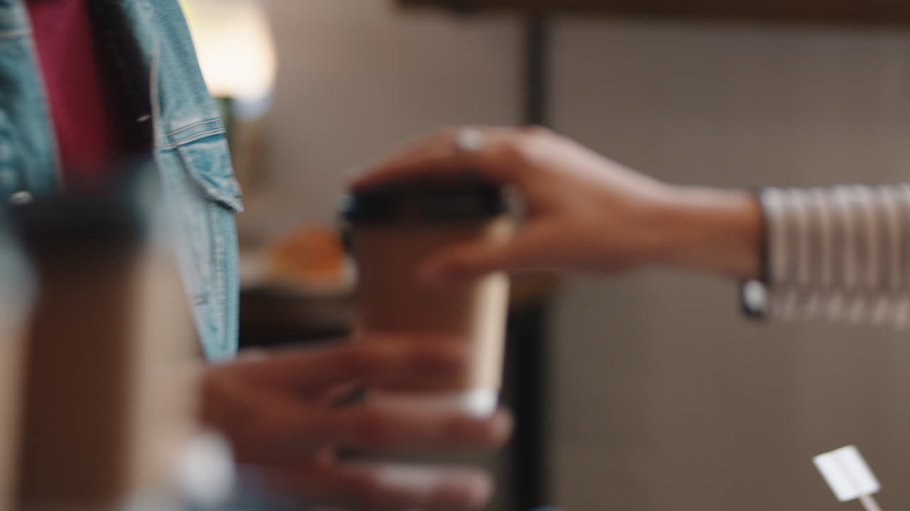 카페에서 다양한 사람들이 커피를 구입하고 바리스타 여성이 바쁜 레스토랑에서 고객을 돌리고 있습니다.