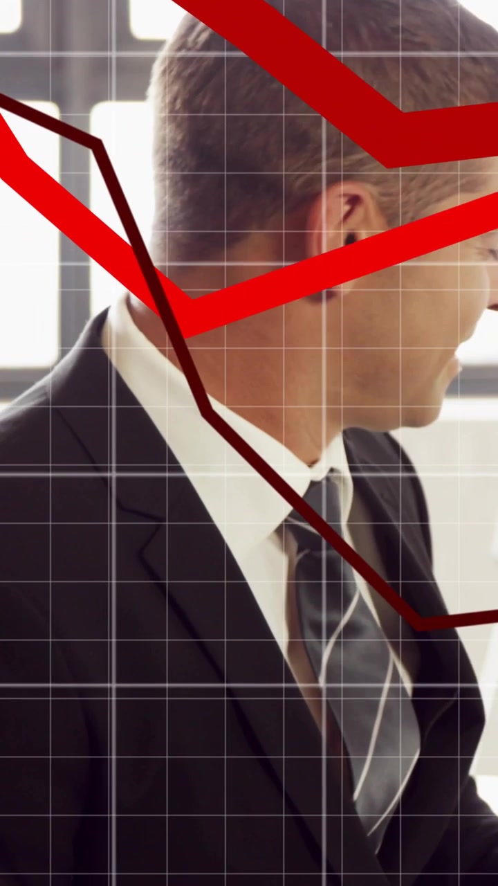 Vertical video: Businessman turning toward moving red charts, leaning while analyzing business data
