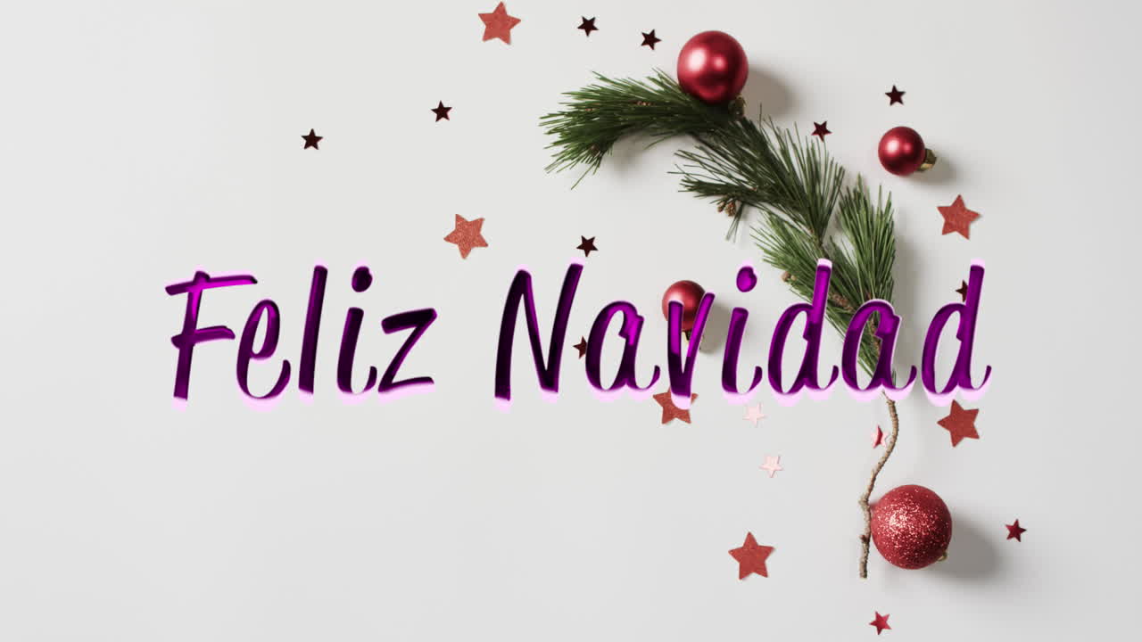 Feliz navidad text in purple with red christmas baubles, stars and tree sprig on white background