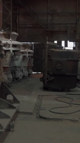 industrial scene in a foundry with heavy machinery and a worker