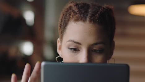 close up beautiful young mixed race woman student using tablet computer in cafe browsing online reading social media messages enjoying sharing relaxing lifestyle