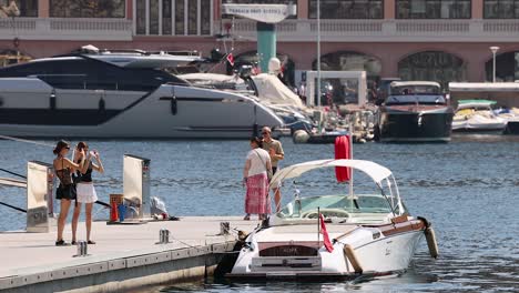 tourists taking photos near a docked boat