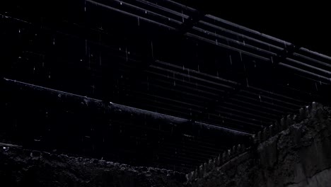 rain drops falling from the roof and iron nets also the light is entering