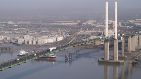 aerial view tracking flowing traffic on the qe2 dartford crossing on the river thames, kent - essex england