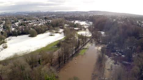 aerial footage from drone showing the river bollin in wilmslow, cheshire after heavy rain and with burst banks and flooding surrounding area