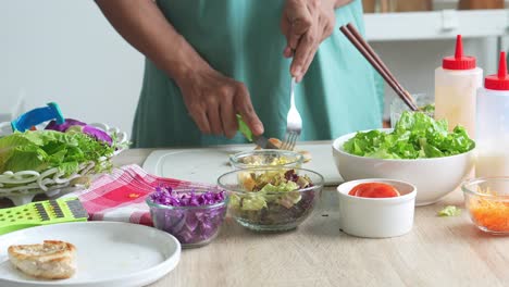 person preparing a healthy meal with fresh vegetables and cooked meat