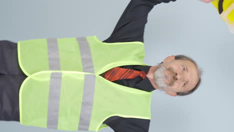 Vertical-video-of-Dancing-old-engineer.