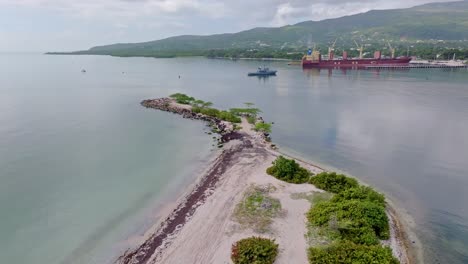 huge cargo ship docked on the harbor of el cayo in the dominican republic