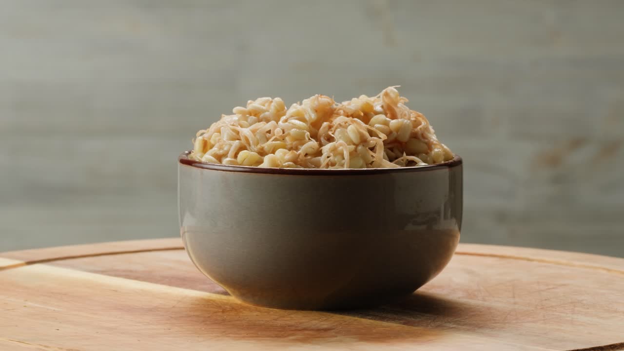 Salted soybean fermented in jar, chinese soy production, marinated food, germinated soy close up in cafe restaurant.
