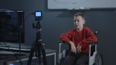 boy in wheelchair giving interview