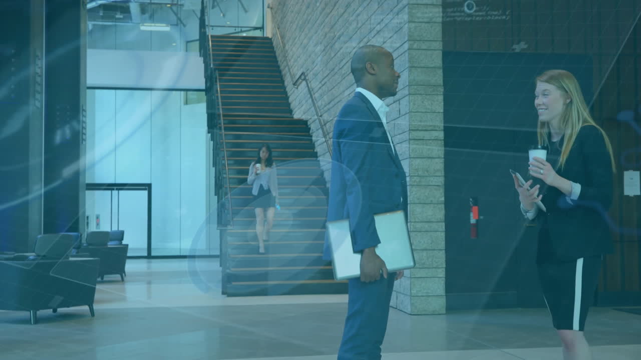 In modern office lobby, business professionals conversing with digital overlay animation