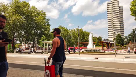 panning motion time lapse of people and public transportation in kaiserslautern city center, germany