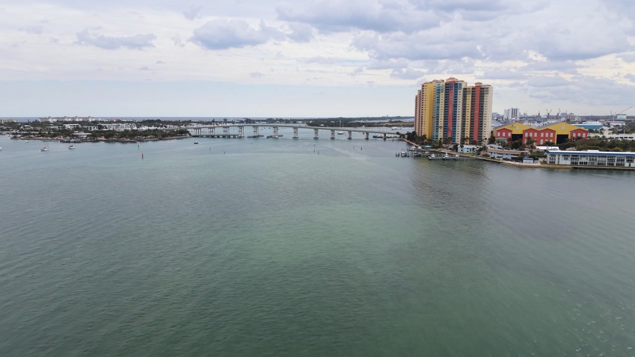 Drone flying south on ICW to Blue Heron Bridge and Phil Foster Park with buildings and Atlantic Ocean in the distance.