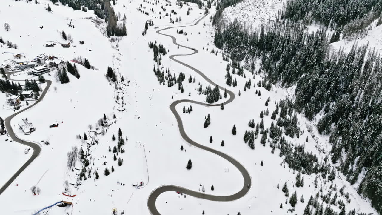 Aerial drone view of the Corvara village covered in snow, in South Tyrol, Dolomites, in northern Italy