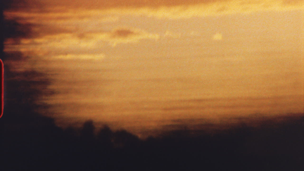 8 mm film - golden sunset hues bathing train window, passenger gazing through landscape sliding past, capturing serene journey's ephemeral beauty and tranquil moments of travel