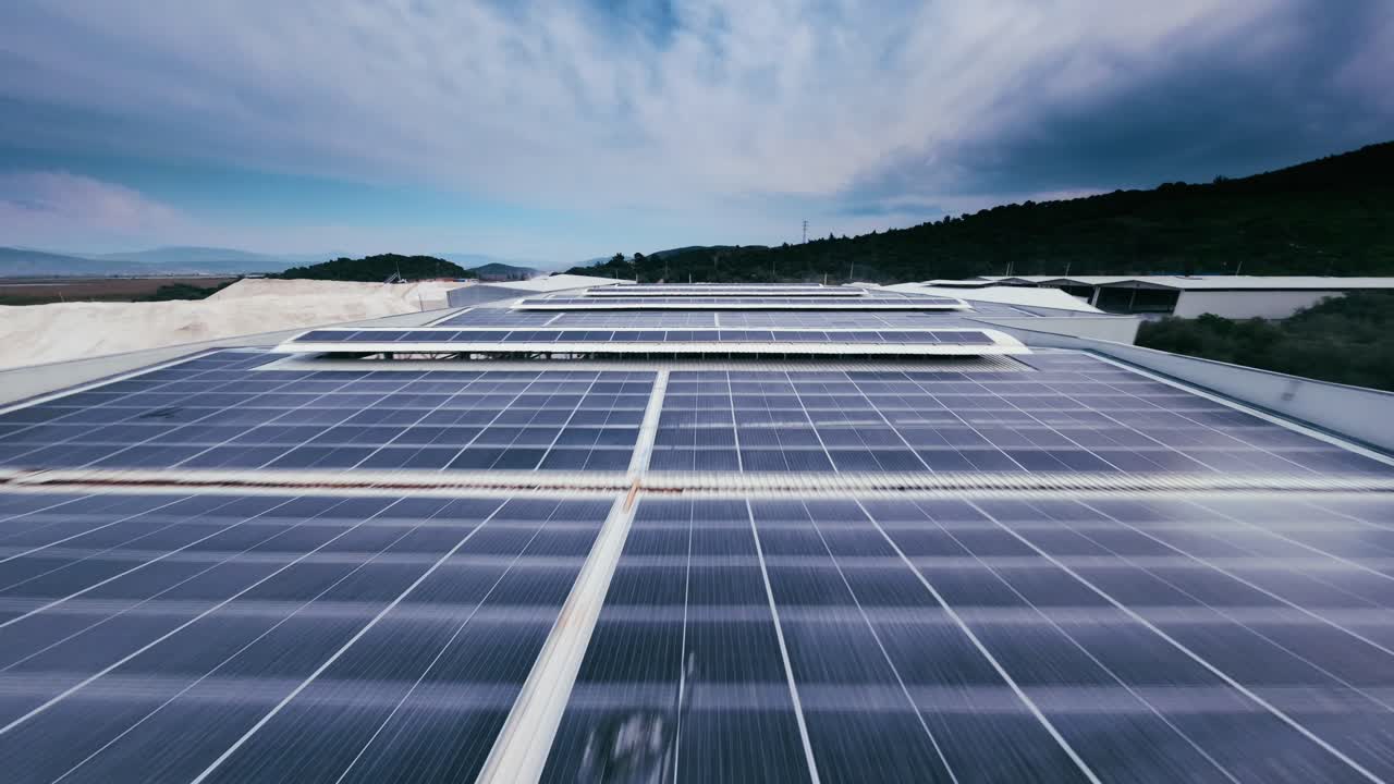Expansive solar power plant with rows of solar panels capturing sunlight in an open landscape