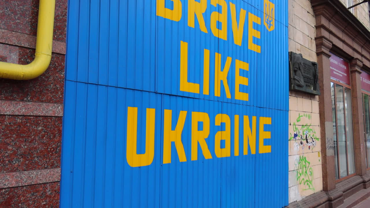 Big blue and yellow sign Be Brave Like Ukraine in Kyiv city center, 4K shot