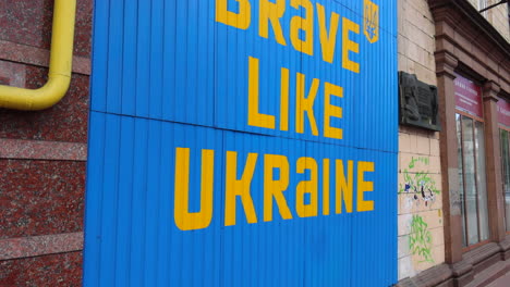 big blue and yellow sign be brave like ukraine in kyiv city center, 4k shot