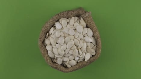 rotation of a full sack of pumpkin grain. top view. isolated