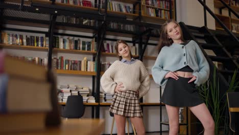 teenage girls dancing in a library