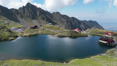 mountain lake balea at transfagarasan, carpathians, transylvania in romania, europe - aerial 4k circling