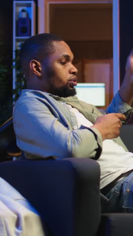 vertical video male remote worker waving at his associates during virtual meeting