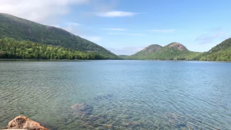 4K-Lady-Contemplates-looking-at-Jordan-Pond-at-Acadia-National-Park-in-Maine