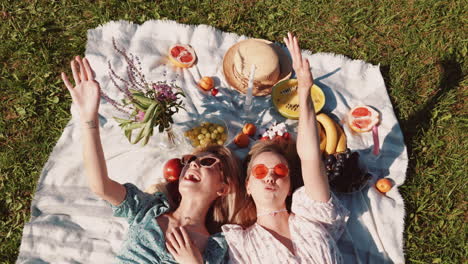 two women enjoying a sunny picnic