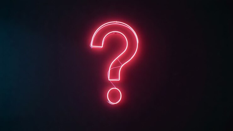 Powering sign on, red neon question mark sign flickering and pulsing brightness in dim studio