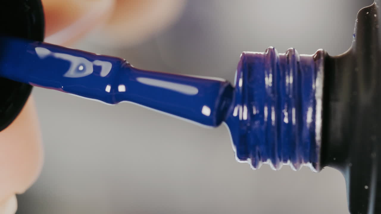 Applying Blue Nail Polish