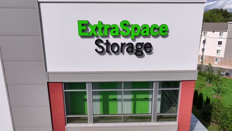 aerial close up of extraspace storage sign on building. american self storage unit company office house in virginia. real estate investment trust.