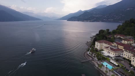 barcos que navegan por el lago de como pasando por hoteles históricos en bellagio, lombardía, italia