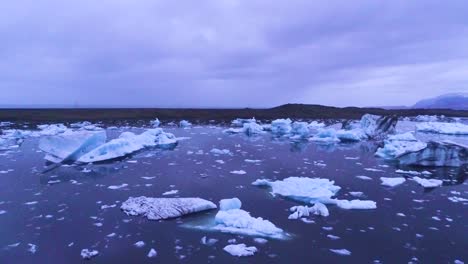 drone aerial over icebergs in a glacial bay suggest global warming in the arctic at jokulsarlon glacier lagoon iceland night 2